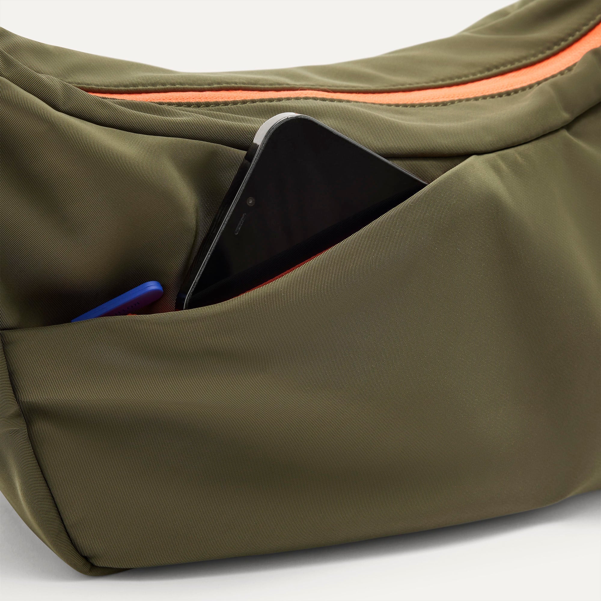 The Travel Sling in Forest  shown closed from the top showcasing the side pocket.