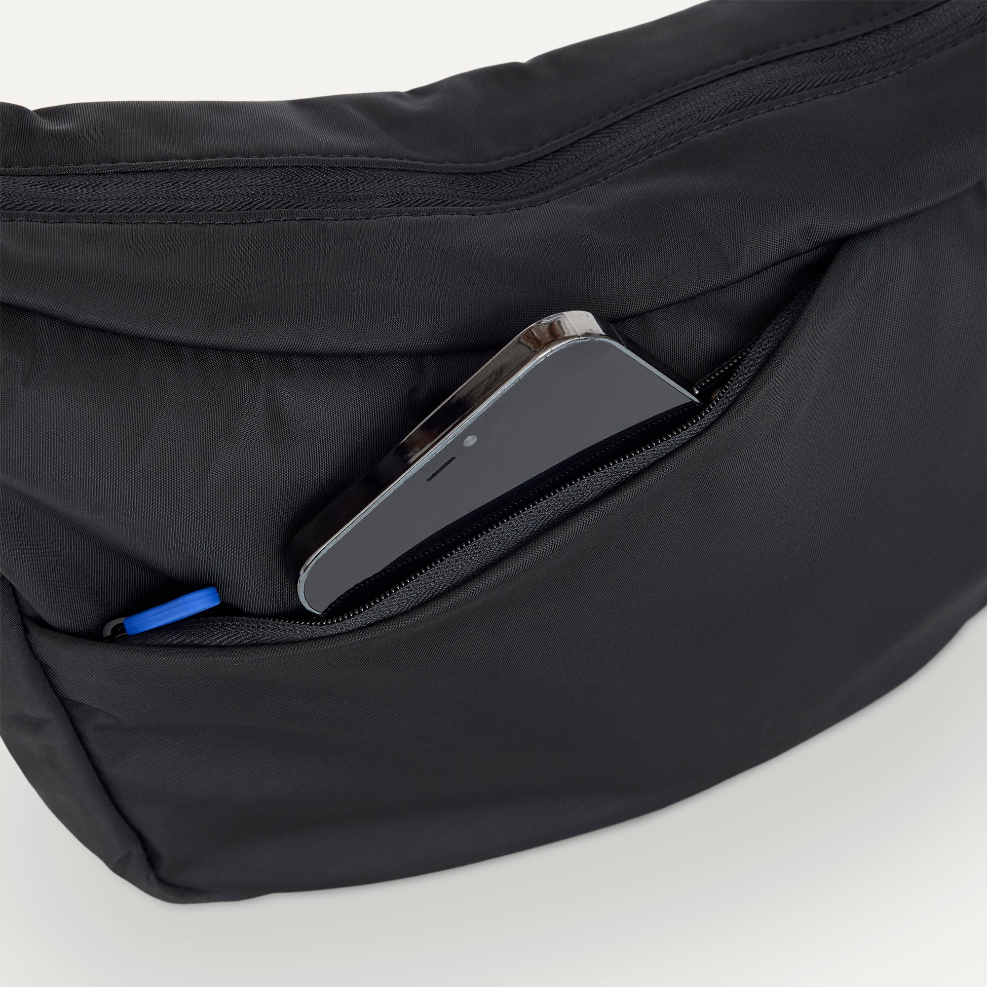 The Travel Sling in Ink  shown closed from the top showcasing the side pocket.