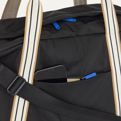 The Travel Duffle in Ink shown closed from the top, focusing on the side pocket. 