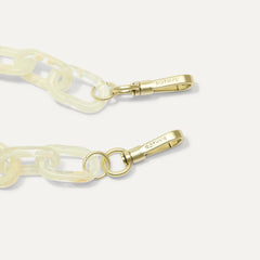 A close-up of The Shoulder Strap in Opal White Chain, focusing on the end snap hooks. 