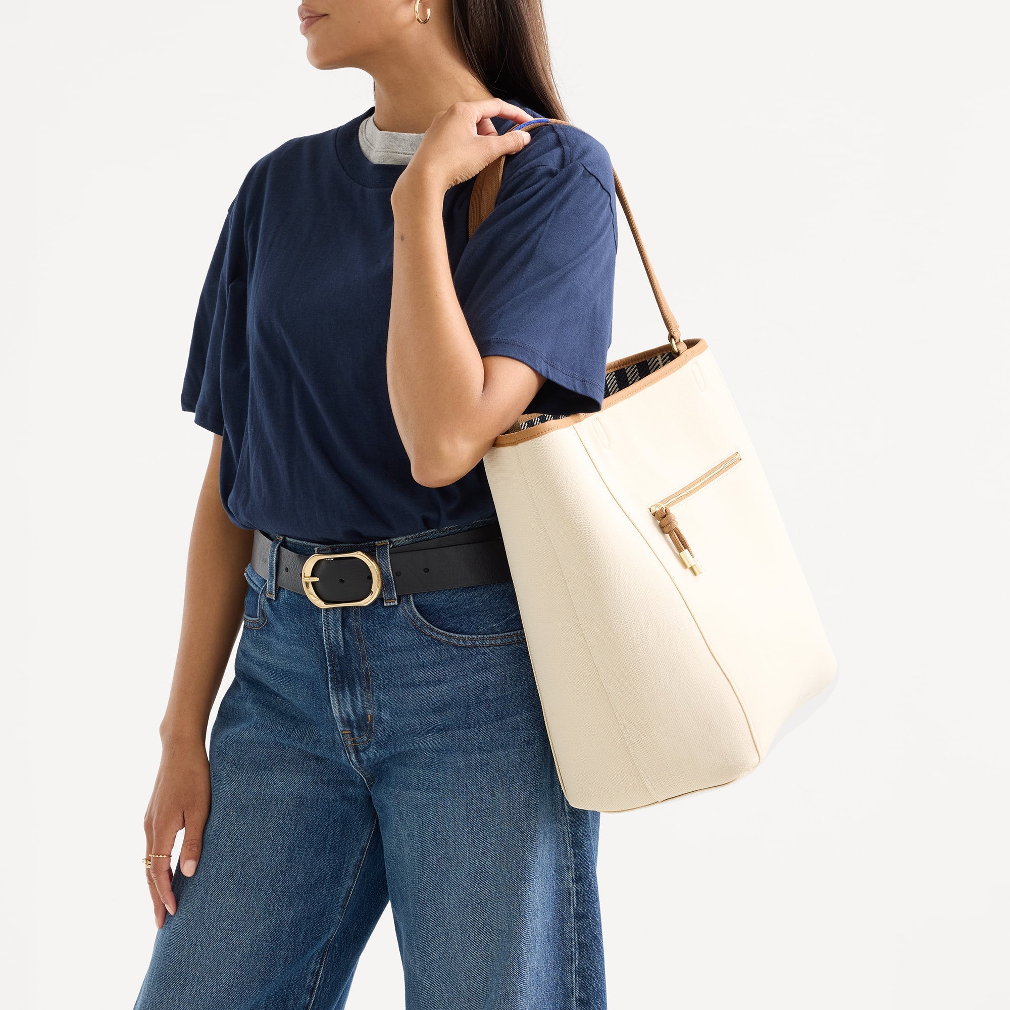 hover | Model carrying The Two-Way Tote in Shadow showing the solid ivory side.
