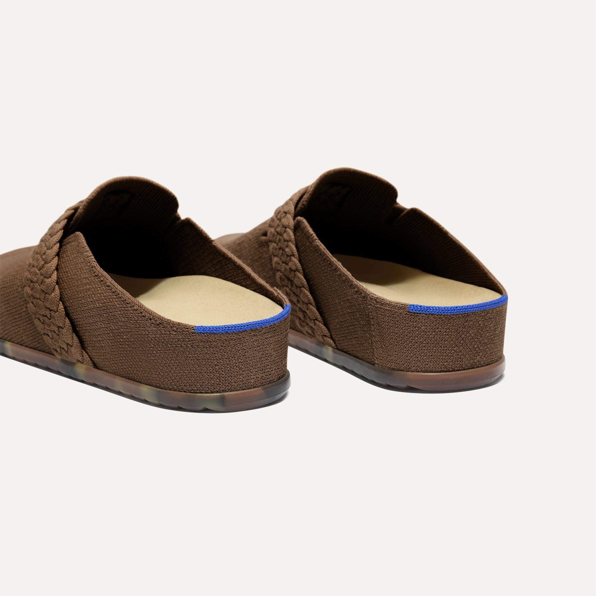 Close up of the heel of The Braid Clog in Acorn, with Rothy's signature blue halo. 