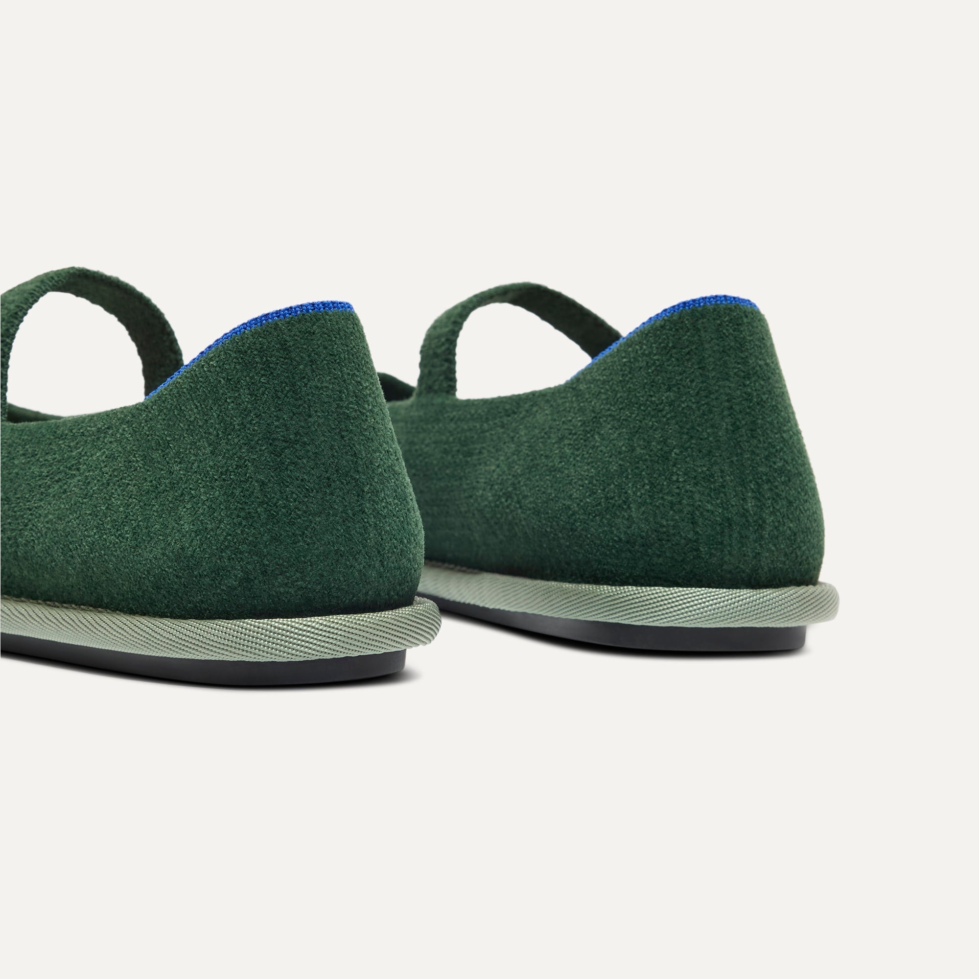 Close up of the heel of The Cruiser Mary Jane in ReVelvet Woodland, with Rothy's signature blue halo. 