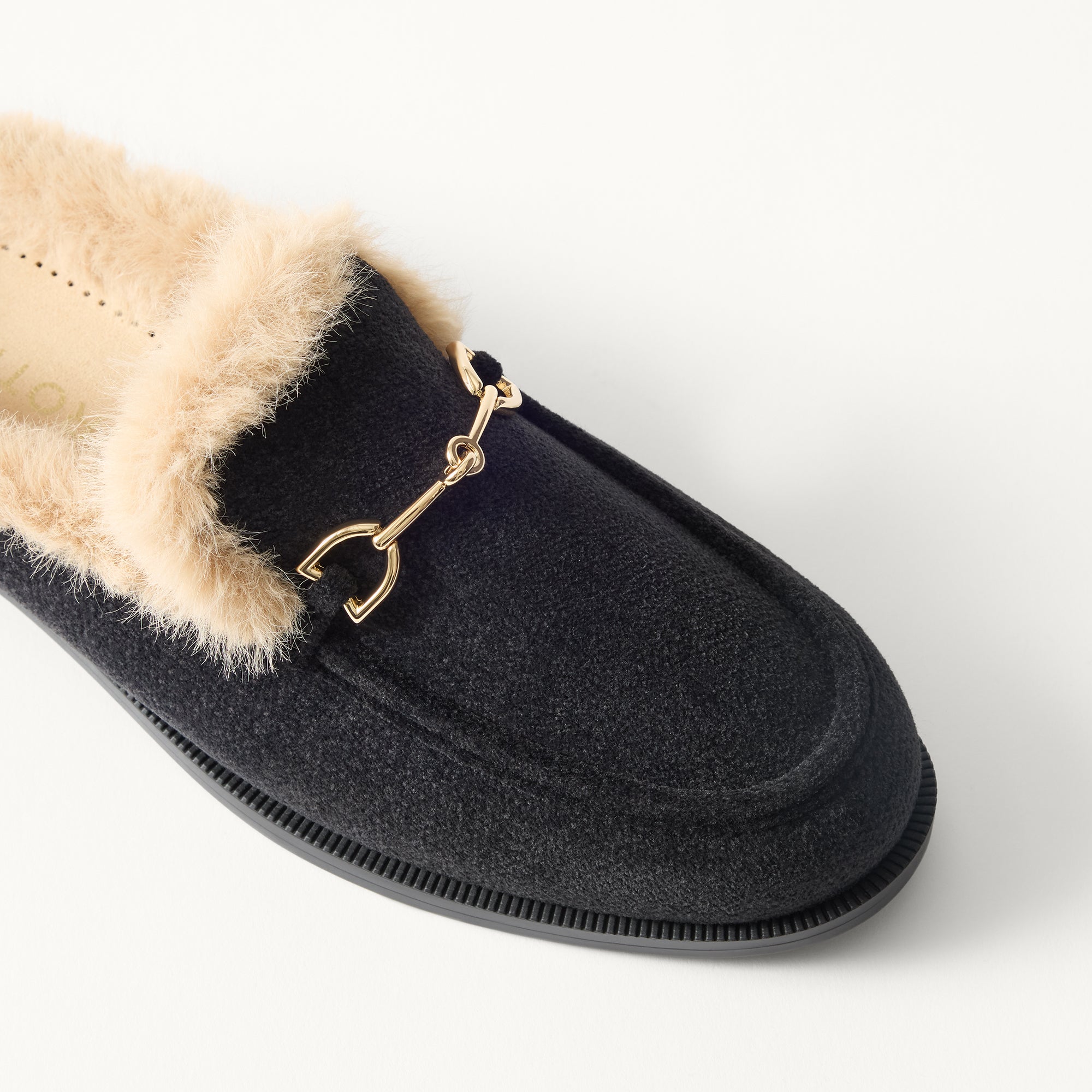 macro | Close up of the toe and vamp of The Après Loafer Mule in ReVelvet Black, showing the double bit detail on top.