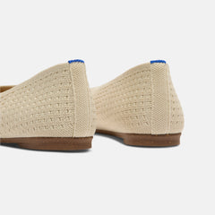 Close up of the heel of The Max Square Ballerina in Off White Mesh with Rothy's signature blue halo.