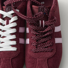 Overlay:: Extra pair of laces included—swap for a new look anytime. | Alt:: Close up of the top of The Ivy Sneaker in ReVelvet Syrah, showing different lace choices.