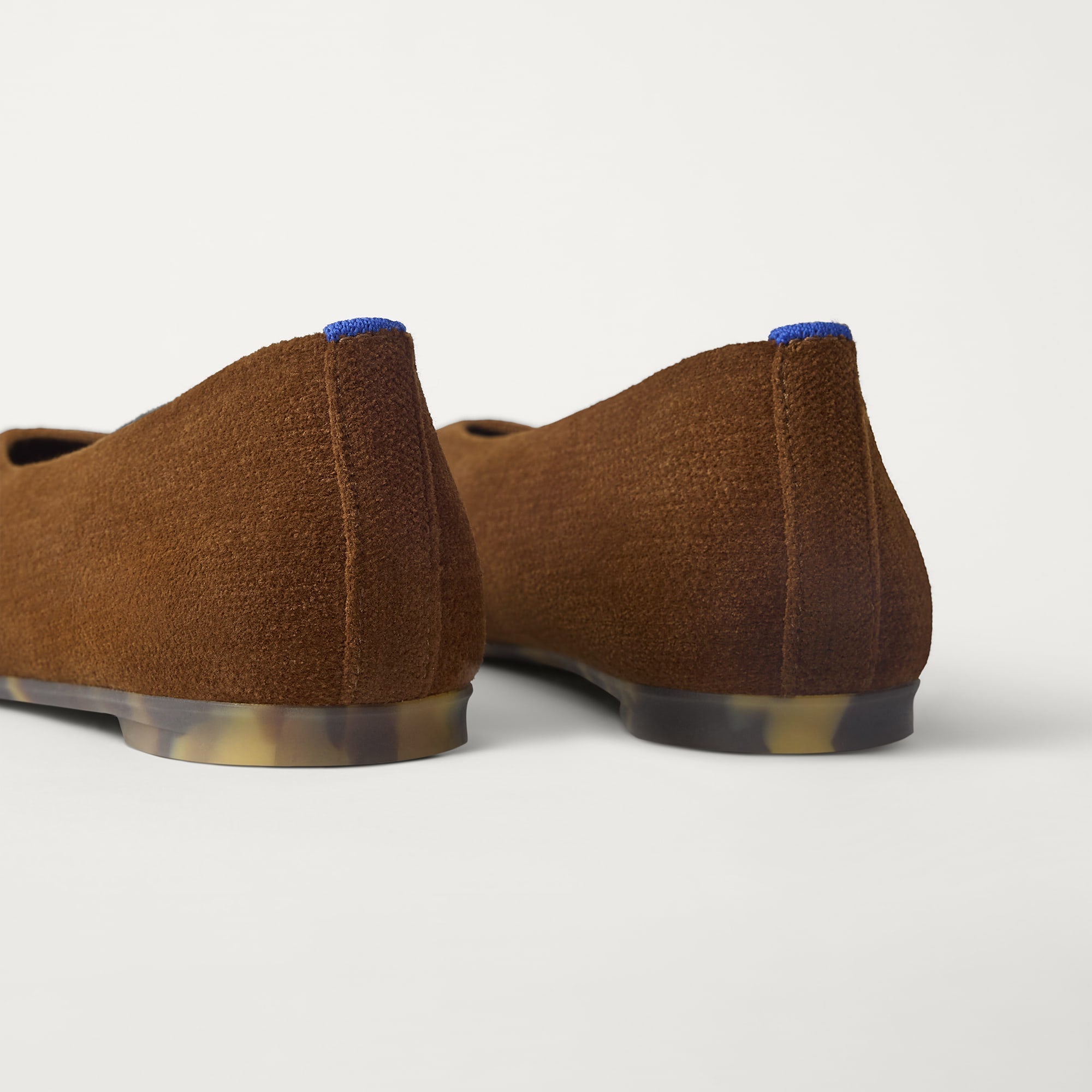 Close up of the heel of The Max Square Ballerina in ReVelvet Russet with Rothy's signature blue halo.