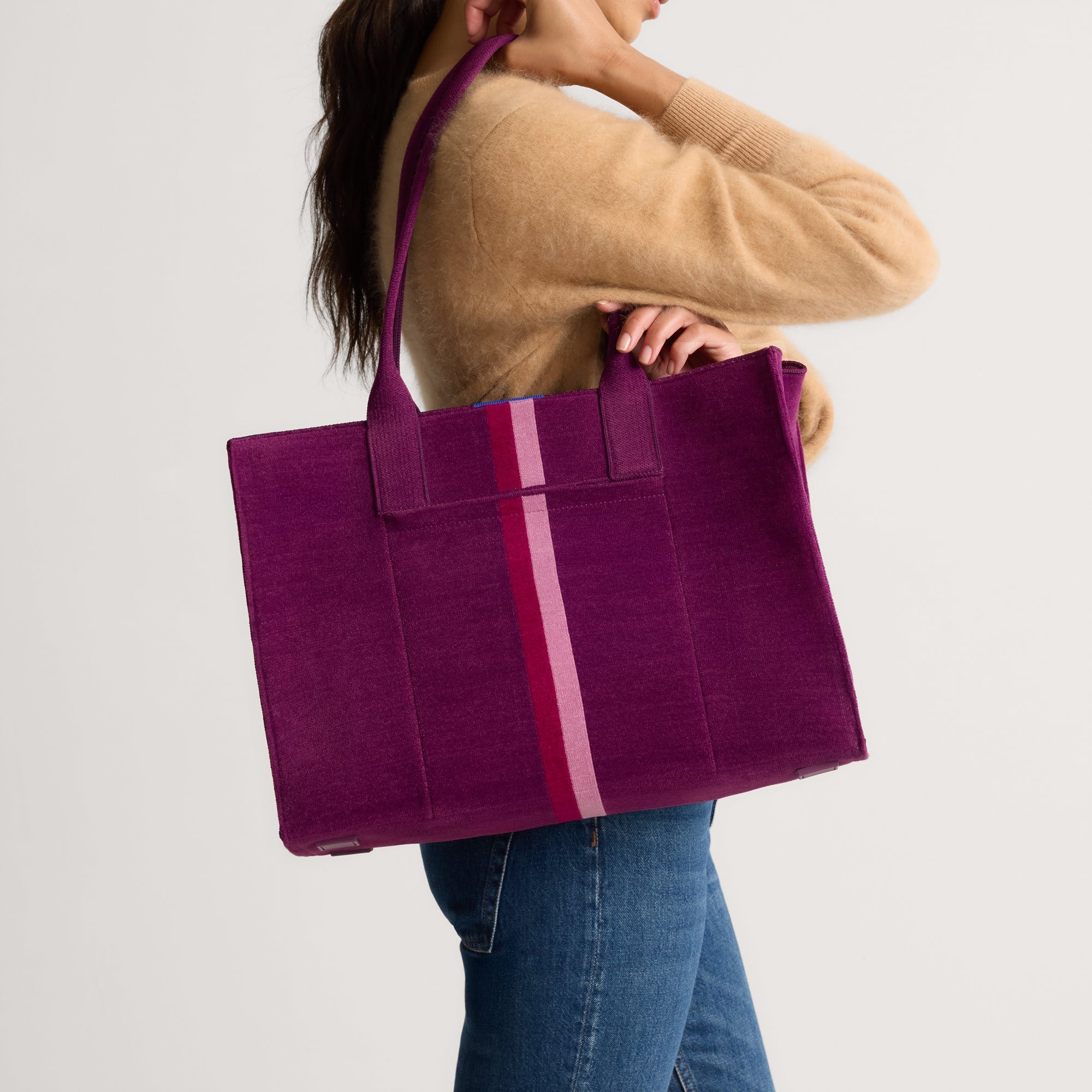 hover | The Classic Tote in ReVelvet Orchid, worn over the shoulder by a model, shown from the side.