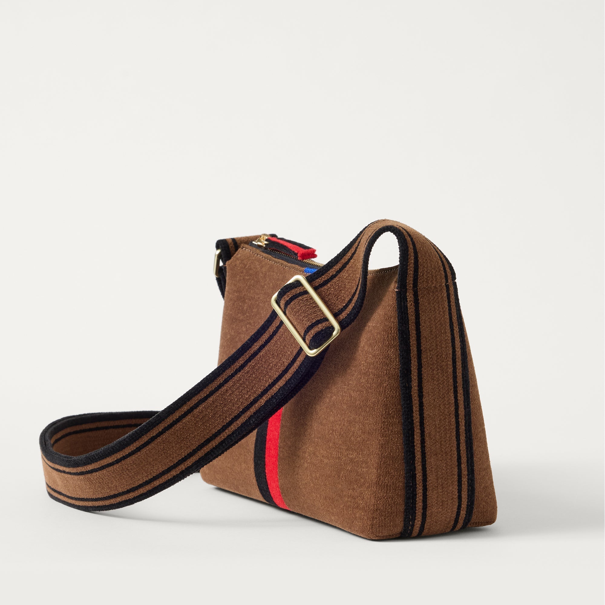 The Casual Crossbody in ReVelvet Cinnamon Stripe, shown from the side at an angle.