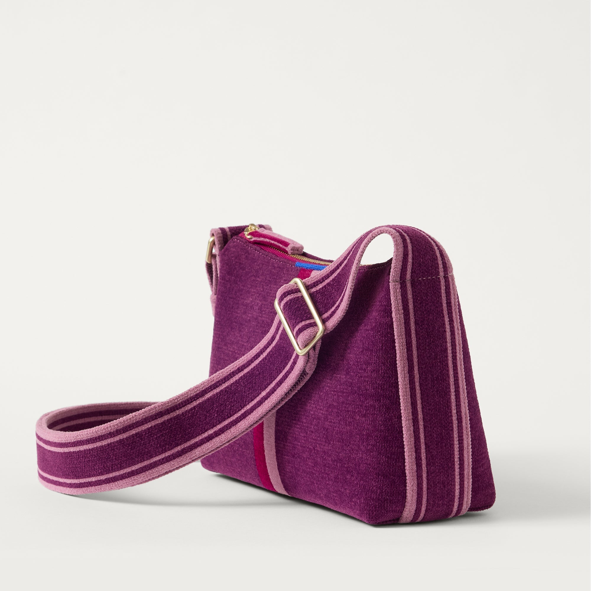 The Casual Crossbody in ReVelvet Orchid, shown from the side at an angle.