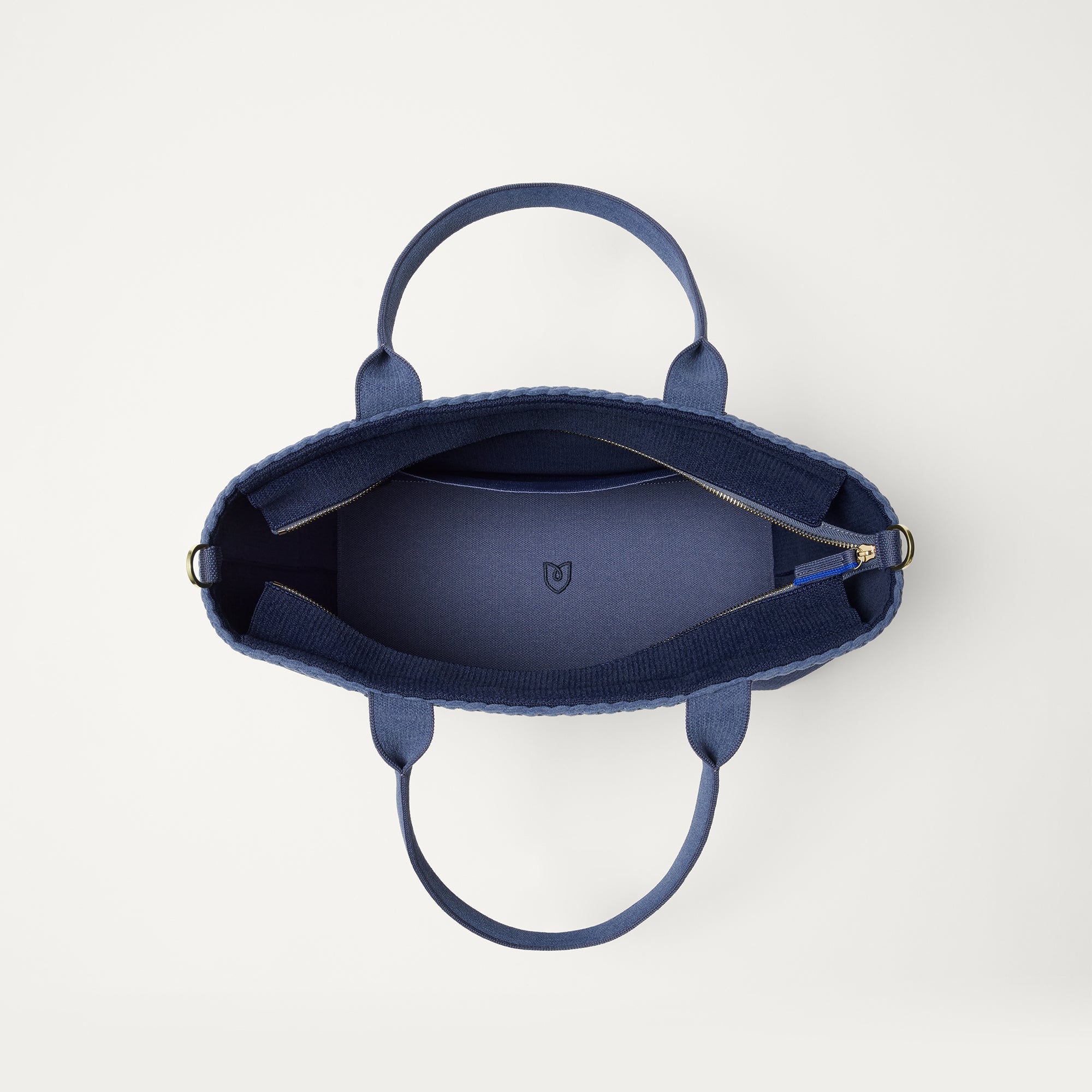The Lightweight Zip Tote in ReVelvet Deep Navy, shown from above with the interior exposed.