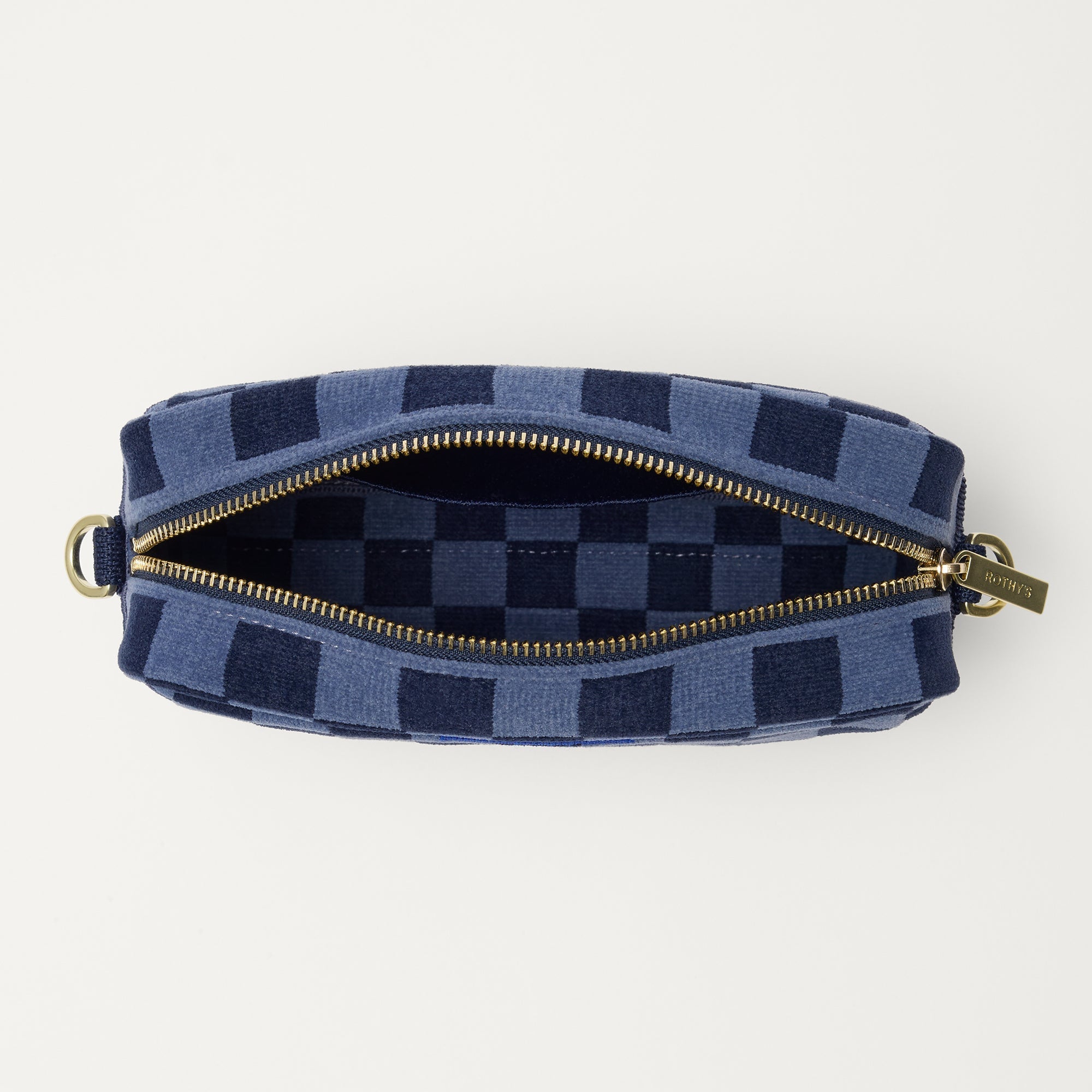 The Crossbody Camera Bag in ReVelvet™ Blue Ink, shown from above, with the interior exposed.