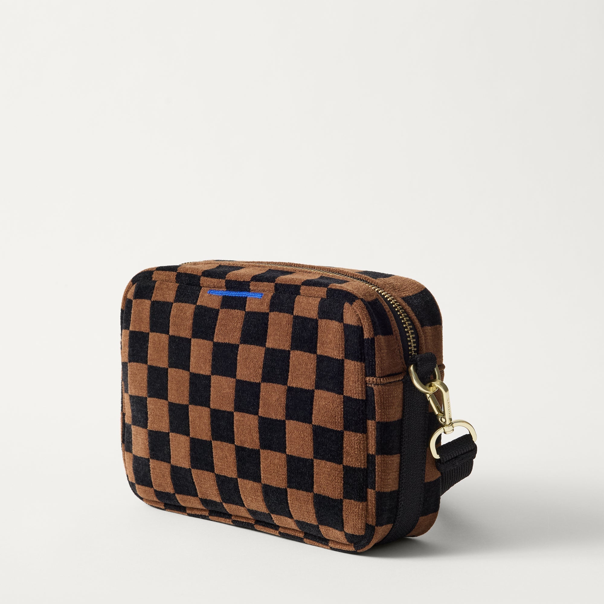 The Crossbody Camera Bag in ReVelvet™ Umber Check, shown from the side. 