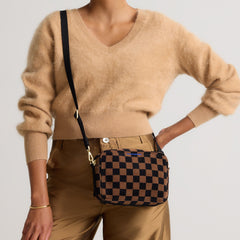 hover | Model wearing The Crossbody Camera Bag in  ReVelvet™ Umber Check, shown from the front. 