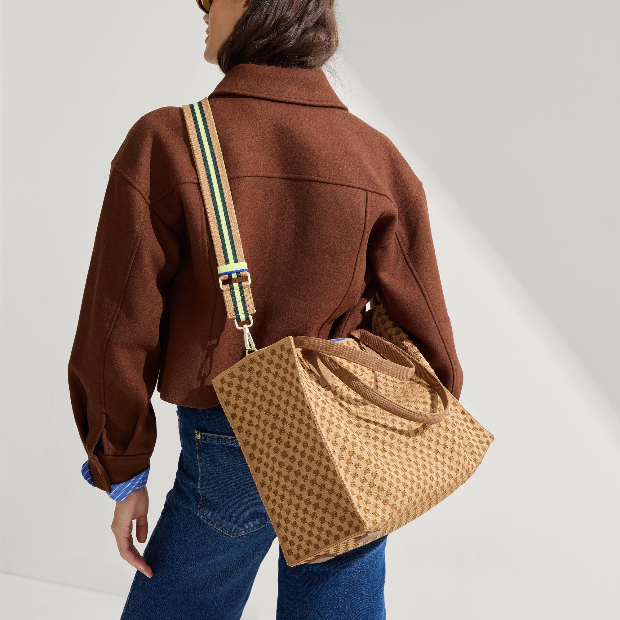 hover | Overlay:: Shown with The Crossbody Strap (sold separately.) | Alt:: The Classic Tote in Hazelnut, worn as a crossbody by a model, paired with The Crossbody Strap in Neon Pine Stripe.