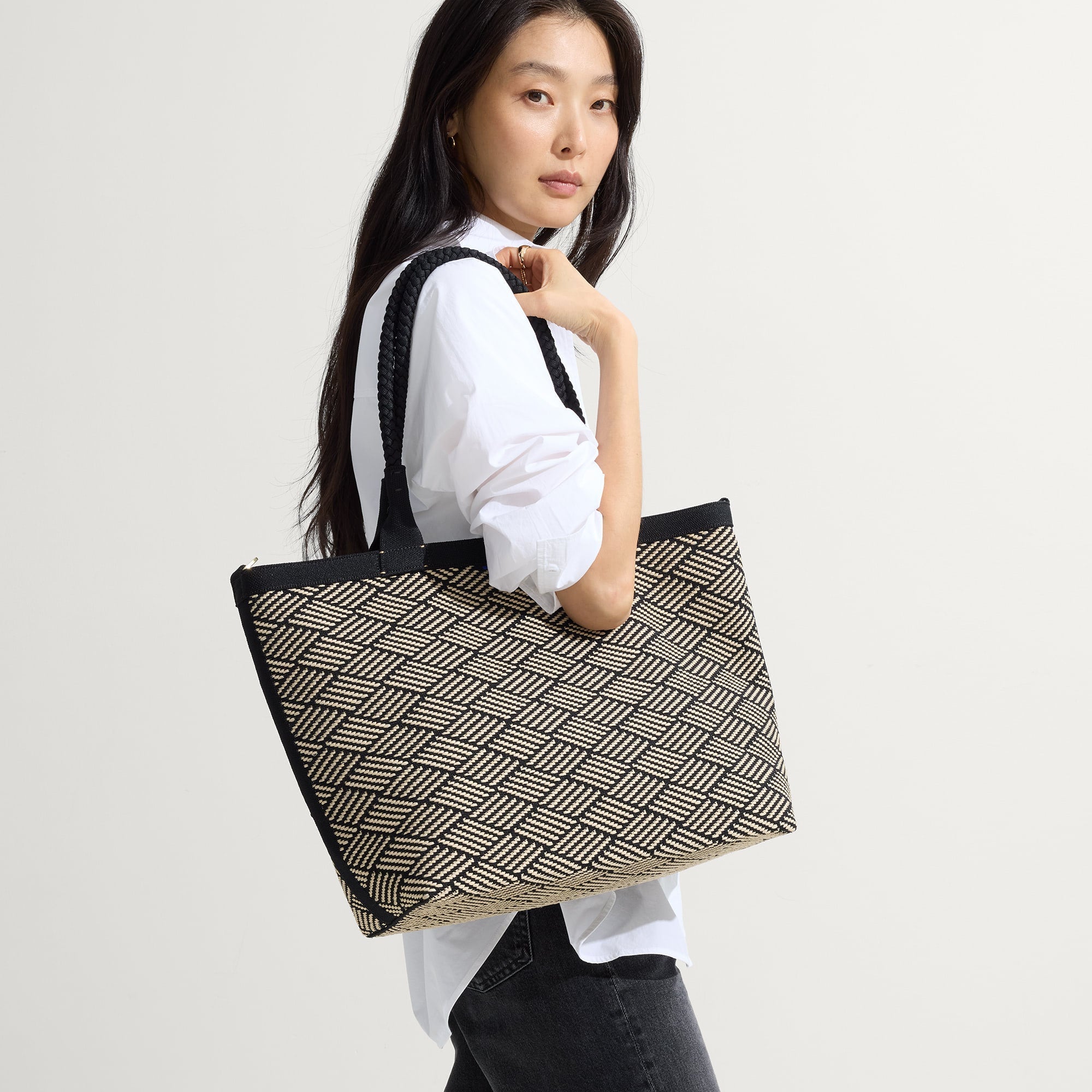 hover | Model shown holding The Lightweight Zip Tote in Polar Zig Zag.